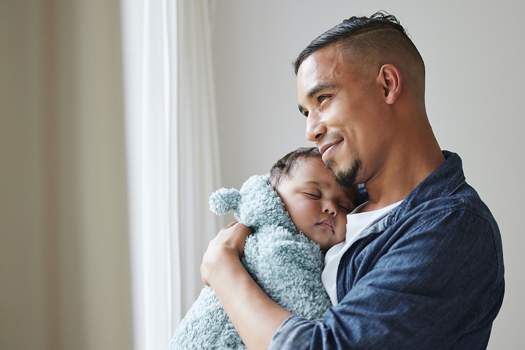 Newborn Held by Hispanic Father Attending Fatherhood Program at Oasis Pregnancy Care Centers